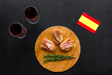 Welcome to Spain. Parma ham and Spanish flag, top view