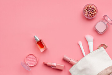 Makeup accessories in cosmetic bag - brushes and brown pink shade cosmetic products, top view