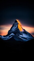 Dark Mountain Peak at Sunset with Golden Sky