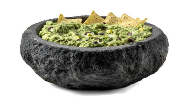 Guacamole in a stone bowl, chunky avocado di,p tortilla isolated on a white background