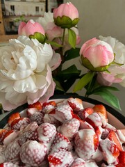 Sliced Strawberries with  whipped cream and sugar. A sweet spring treat.Food background