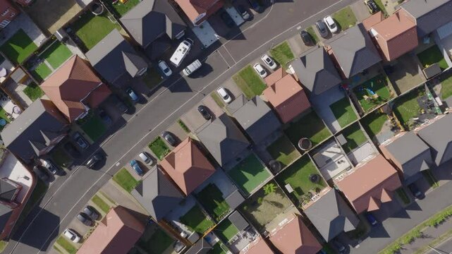 Top down aerial view of new build suburban houses in the United Kingdom. Housing market and suburban lifestyle concept.