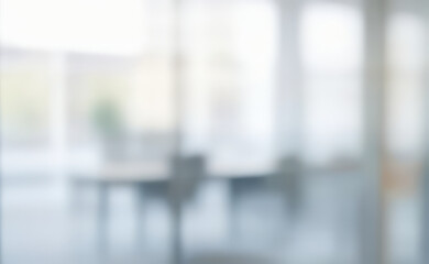Blurred interior view of a room with table and chairs bright light.