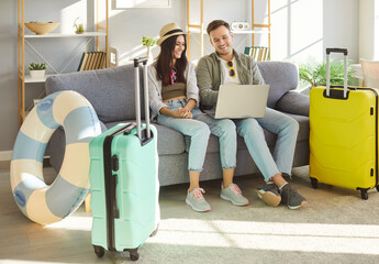 Happy tourists, honeymoon couple, young family online choosing trip, booking tickets flight from...