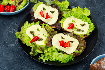 A group of sandwiches with Halloween decorations.