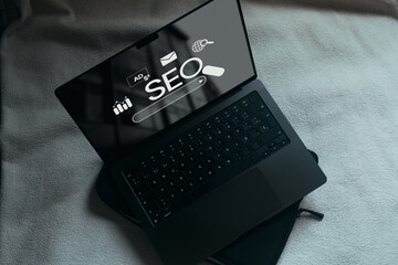 Laptop with SEO icons for analysis on screen. SEO Search Engine optimizing your website to rank in...