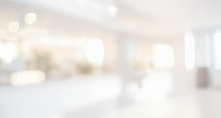 Blurred bright white room interior with soft light bokeh and neutral tones.