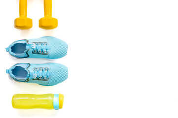 Sports equipment flat lay. Sneakers and dumbbells for fitness