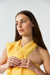 Elegant summer fashion showcase featuring a beautiful young woman in a striking yellow outfit