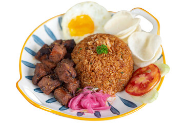 Traditional fried rice with beef saikoro as topping. Served with sunny side up, crackers, shallots pickle and sliced tomatos. Isolated photo. Perfect for menu, advertising or commercial use