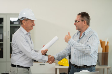 Obraz premium Close up shake hands, Architect construction engineer plan, investing in real estate.