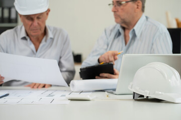 Fototapeta premium Engineering Team Collaborates on Blueprint Model in Corporate Office.