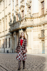 young beautiful woman in vintage suit in european city