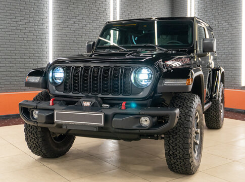 Jeep Wrangler Rubicon two-door pickup 4x4 black color in showroom. Exterior Jeep Rubicon Wrangler two-door pickup truck American off-road us vehicle. American SUV.