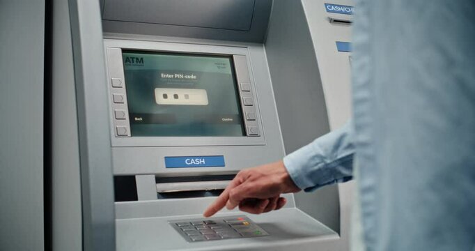 ATM Machine: Unrecognizable Man Entering PIN Code on Keypad, Choosing Money Withdrawal Transaction, Entering Amount and Taking US Dollars from Cash Dispenser. Banking System and Operations. Close Up.
