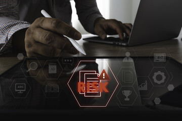 Risk managemen insuranc control image shows person using stylus digital tablet with warning sign...