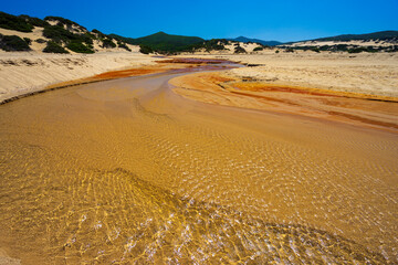 The heavily polluted Irvi River, which carries highly toxic heavy metals from the abandoned Montevecchio mine to the Spiaggia di Piscinas beach, Sardinia, Italy