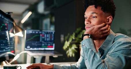Man, tired and computer screen with trading, charts or burnout for revenue report in office at company. Person, bored and monitor at night, graph or fatigue with low energy for stock market at agency © Jessy25/peopleimages.com