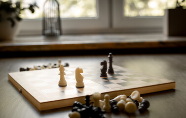 White chess knight piece and other pieces on chessboard during the game