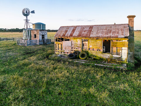 Rustic farmhouse with windmill in a rural landscape of Victoria