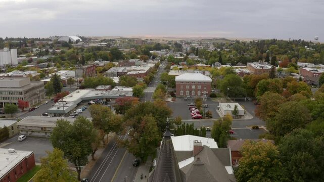 Aerial Tilt Up Scenic View Of Church In Residential Town Under Cloudy Sky - Moscow, Idaho