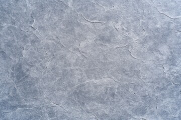 Naklejka premium Light gray stone texture with natural cracks and subtle patterns, ideal for backgrounds or architectural surfaces.