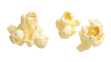 Three pieces of popped popcorn isolated on black background with buttery texture visible closely on transparent background