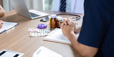 Doctor Team Meeting. Focused healthcare professionals engaged in medication planning.