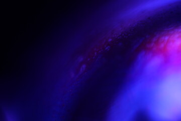 Deep violet liquid surface on black background, oil stains movement, bright chemistry, surreal background, deep galaxy atmosphere 
