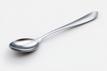 A single, gleaming silver spoon rests on a stark white background.  Its simple elegance is captivating.