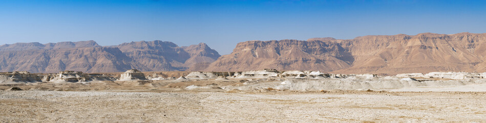 Panoramic view of Negev Desert with Orange sandstone mountains with a blue sky in Eilat, Israel