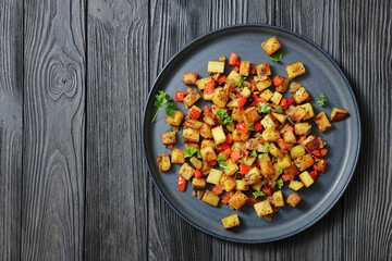 golden fried potatoes cubes with red bell pepper