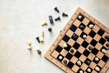 White and black chess pieces on chessboard during the game, top view