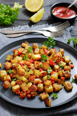 golden fried potatoes cubes with red bell pepper