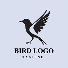 Black silhouette bird logo design with a tagline. Simple, elegant design suitable for a business, nature, or environmental organization.