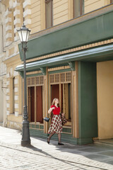 young beautiful woman in vintage suit in european city