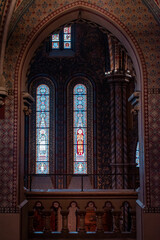 Fototapeta premium A Gothic-style cathedral tower with intricate architectural elements and stained glass.
