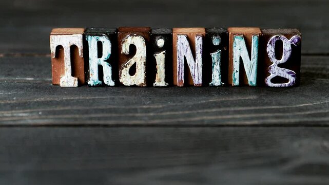 Training. Alphabet blocks on a wooden texture background. 4K video