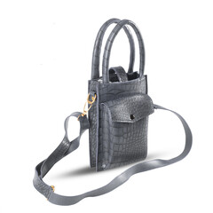 Beautiful luxury handmade crocodile skin bag made of genuine crocodile leather isolated on white...