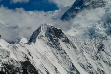 Obraz premium Tian Shan mountains snow peaks and steep slopes in Kazakhstan and Kyrgyzstan border with China. South Inylchek glacier, Enilchek Khan Tengri and Pobeda Victory peak base camp in Pamir mountain range
