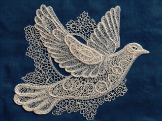 Delicate, white lacework dove design on a dark background.
