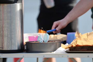 lighting the 40th birthday candles on the cake