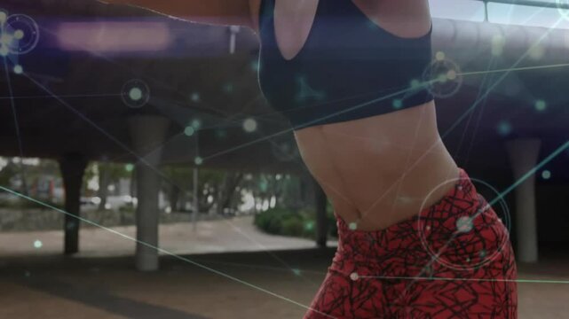 woman wearing sports bra and red leggings jogging under overpass, showing fitness tech overlay