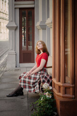 young beautiful woman in vintage suit in european city