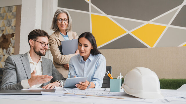 The home design architects are reviewing the house plan draft, the project commissioned by the client, and the custom design before delivery. Interior design and decoration ideas copy space