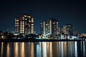 Naklejka premium Night cityscape reflected in calm water (1)