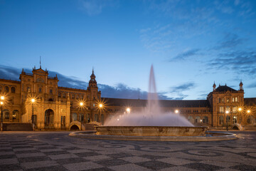 The Plaza de Espana, in Seville, Andalusia, Spain, at sunrise. Focus on the water fountain in the middle of the plaza. Long exposure 
