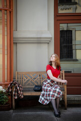 young beautiful woman in vintage suit in european city