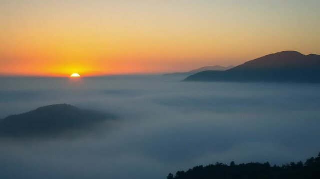 time lapse foggy or mountains tops over clouds sunrise sky. A sea of fog is formed from stratus. Foggy valley mount ridge nature. Time lapse Beautiful foggy and cloudy slow moving Aerial