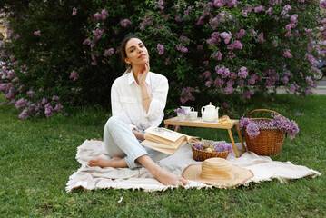 Woman Embraces Fragrant Lilac Blooms In Spring